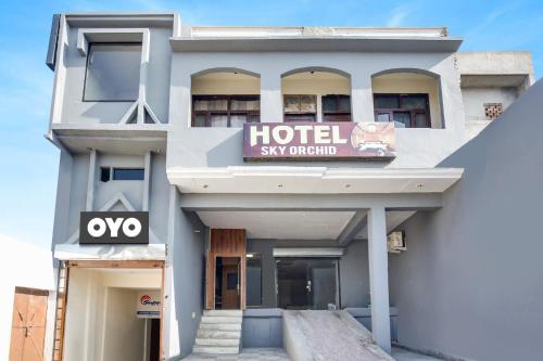 un edificio con un cartel original del cielo del hotel en Super OYO Hotel Sky Orchid en Ludhiana