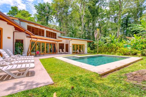 a house with a swimming pool in the yard at Shawandha Villas in Punta Uva