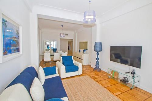 a living room with blue and white furniture at Promenade des Anglais - Sea View 2bdr in Nice