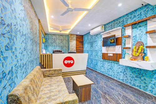 a lobby of a coop restaurant with blue walls at OYO Hotel Golden in Vadodara