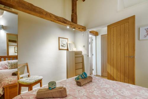a bedroom with a bed with two towels on it at Gunn Cottage - Dog-friendly enclosed garden in Santon Bridge