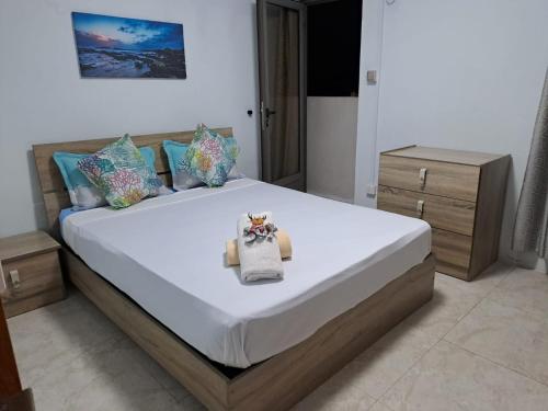 a bedroom with a large bed with a white mattress at West Beach in Flic-en-Flac