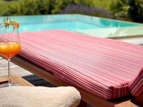 a red and white towel on a table with a drink at Das Rizzi in Grössing
