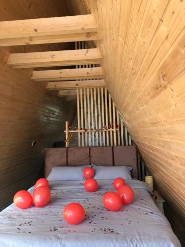 łóżko z czerwonymi kulkami na poddaszu w obiekcie Azalea Chalet w mieście Divčibare