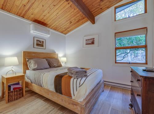 a bedroom with a bed and a wooden ceiling at LUX Popular Lakefront, Close to Ski, Snowboard, Games in Bushkill