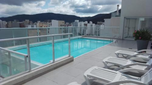 a balcony with a swimming pool on top of a building at B&B Unique in Salta