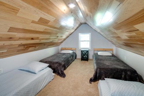 2 łóżka w pokoju z drewnianym sufitem w obiekcie Waterfront Home Allegheny River Access, Dock Slip w mieście Ford City