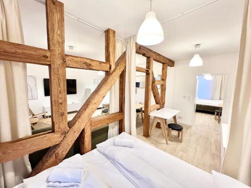 a bedroom with a bed and a living room at Apartamenty Teofila Magdzińskiego 5 in Bydgoszcz