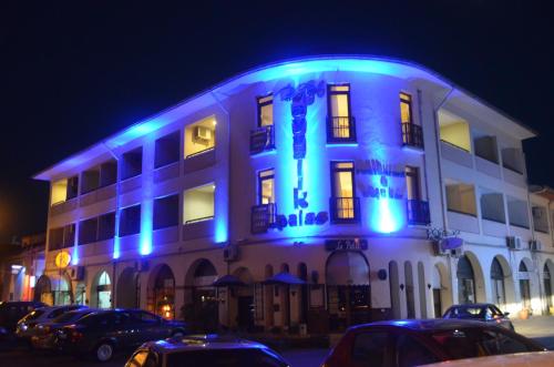 a lit up building with blue lights on it at Ayvalık Palas Hotel in Ayvalık