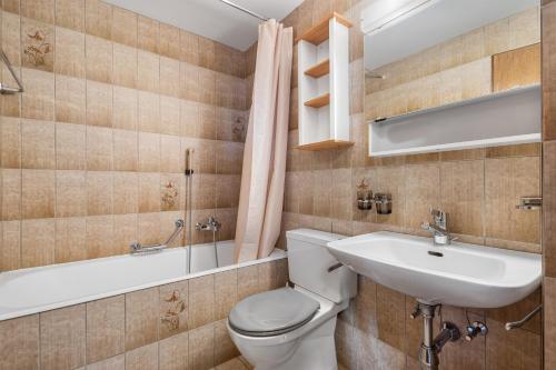 a bathroom with a toilet and a sink and a tub at Alexandra 21 - 4 pers - pres des pistes in Nendaz
