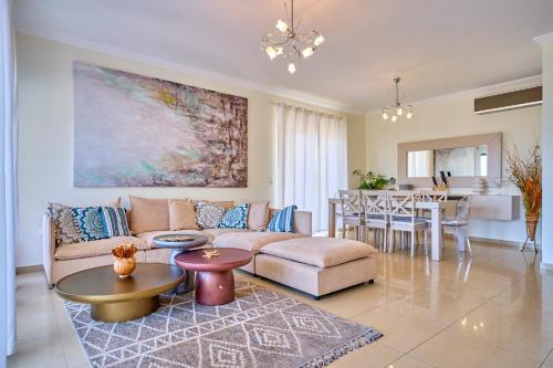 a living room with a couch and a table at Villa Spiros Imerolia Kassiopi in Kassiopi