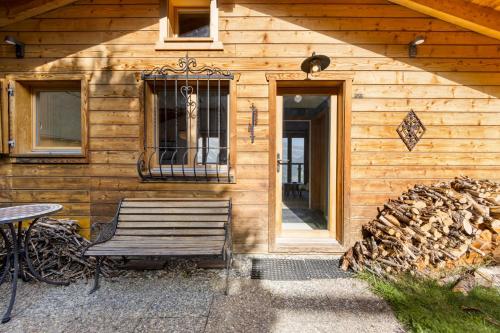 a wooden cabin with a bench next to a door at Silverfox - 6 pers - belle vue in Plan Fey