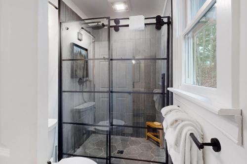 a bathroom with a shower with a glass door at Marble Farm in Waitsfield