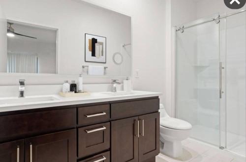 a bathroom with a sink and a toilet and a shower at Staycation near Flamingo road in Las Vegas