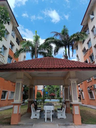 a pavilion with chairs and a table in front of a building at M.FR Homestay Pangsapuri Putra Damai in Putrajaya