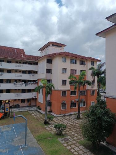 a large building with palm trees in front of it at M.FR Homestay Pangsapuri Putra Damai in Putrajaya