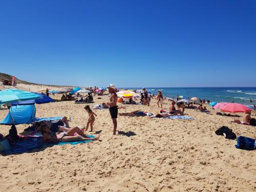 a group of people laying on the beach at les dunes de contis in Saint-Julien-en-Born