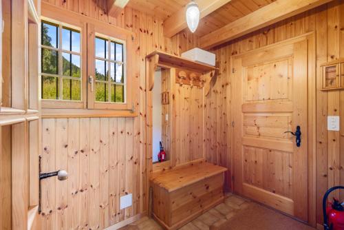 a wooden bathroom with a bench and a window at Gisele - 8 pers - pres des pistes in Nendaz