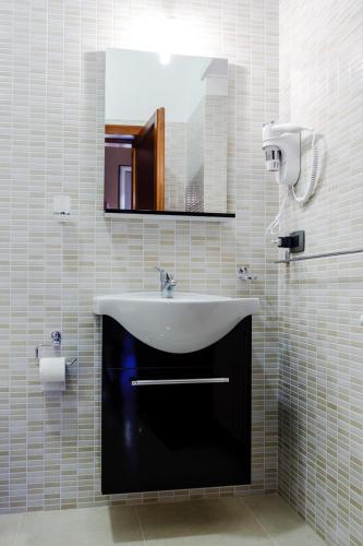 a bathroom with a sink and a mirror at B&B SALento in San Cesario di Lecce