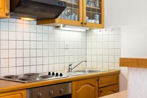 a kitchen with a sink and a stove at Rosablanche B12-B13 - 4 pers - au pied des pistes in Siviez