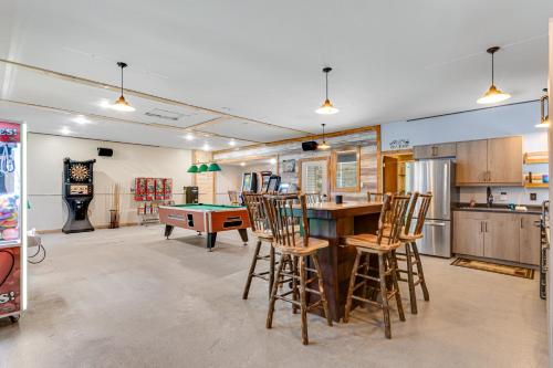 a kitchen with a ping pong table and chairs at The Woodland in Conover