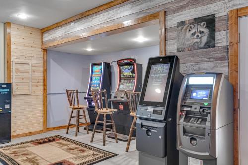 a room with four video game machines in a room at The Woodland in Conover