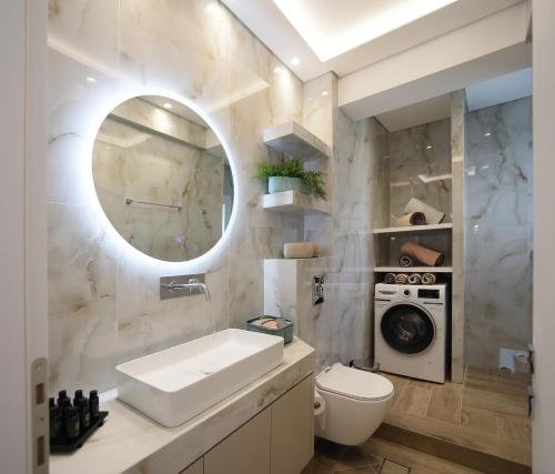 a bathroom with a sink and a washing machine at Sam Casa Luxury Living in Kastoria