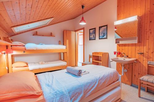 1 Schlafzimmer mit 2 Etagenbetten und einem Waschbecken in der Unterkunft Muverans II F5 - 8 pers - duplex in Nendaz
