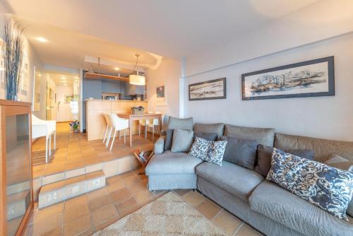 a living room with a couch and a dining room at Anna in L'Escala