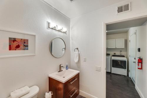 a white bathroom with a sink and a mirror at Stunning Tempe Home with Pool - Near ASU Campus! in Tempe