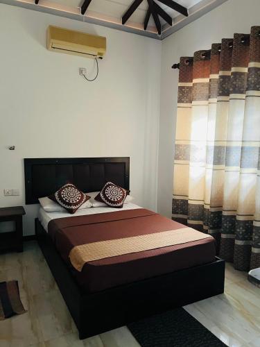 سرير أو أسرّة في غرفة في Tropical Vibes - Kathaluwa