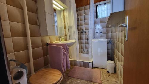 a small bathroom with a toilet and a sink at Perlica in Vodice
