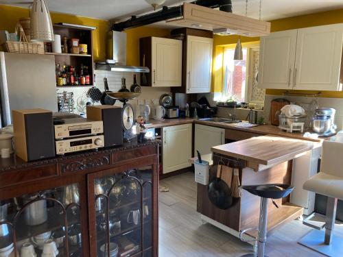 een keuken met witte kasten en een houten aanrecht bij Jacks Court B4c in Stalybridge