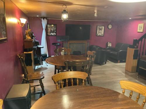 a restaurant with tables and chairs and a couch at B4-Jacks Court in Stalybridge