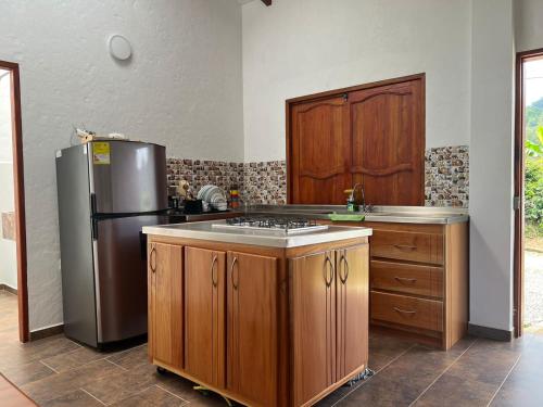 a kitchen with wooden cabinets and a stainless steel refrigerator at Orquideas 3 in Jericó