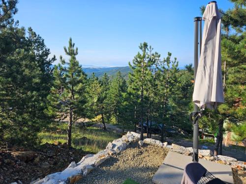 a white umbrella sitting on top of a field at Vila Ivona in Divčibare