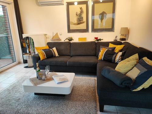 a living room with a couch and a coffee table at Ferienhaus Schwalbenrast in Lembruch