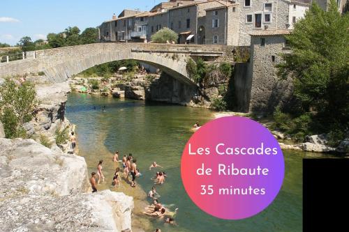 a group of people swimming in the water under a bridge at Cachette Secrète & SPA Narbonne in Narbonne