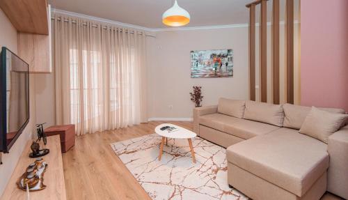 a living room with a couch and a table at Loris Apartaments 205 in Durrës