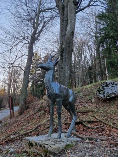 a statue of a deer standing on a rock at Apartmani Vukman in Delnice