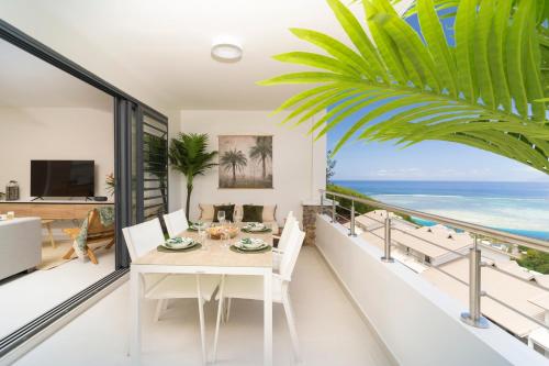 a dining room with a table and a view of the ocean at Tetavake Luxury Suite in Punaauia