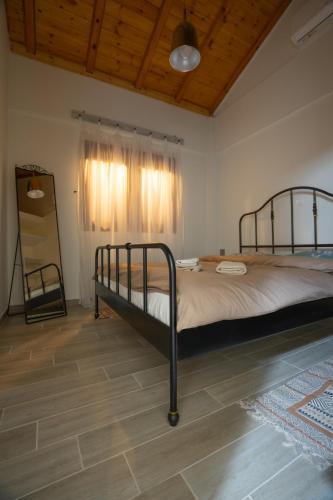 a bedroom with a large bed in a room at Fyllenia Country Home, Aridaia, Pozar Baths in Chrýsa