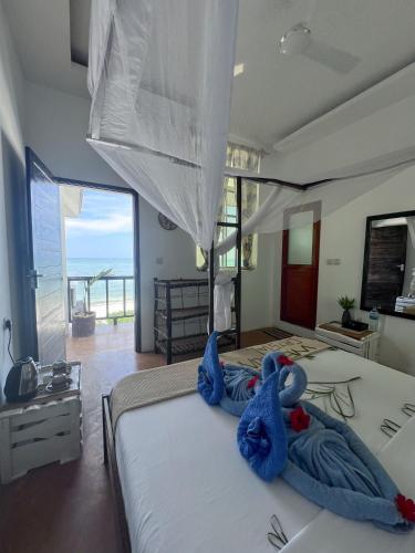 ein Schlafzimmer mit einem Bett mit blauen Handtüchern darauf in der Unterkunft Crystal Beach Nungwi in Nungwi