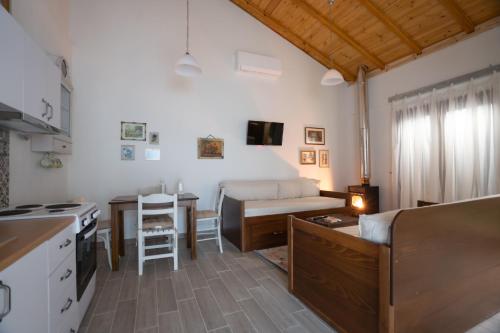 a kitchen and living room with a couch and a table at Fyllenia Country Home, Aridaia, Pozar Baths in Chrýsa