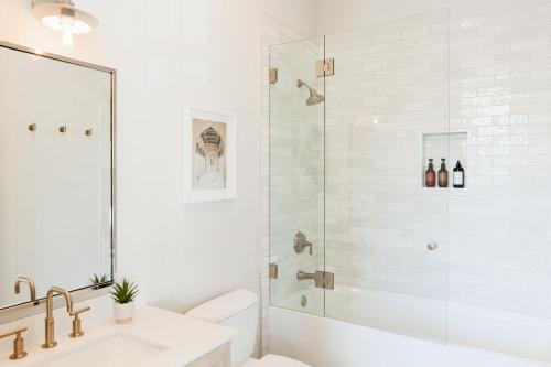 a white bathroom with a shower and a sink at Villa Castillo 2 in Santa Barbara