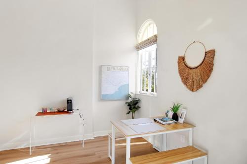 a white room with a table and a mirror at Villa Castillo 2 in Santa Barbara