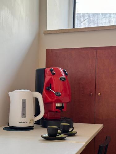 a coffee maker sitting on a counter next to cups at ART SUITE NEL CUORE DI PORTICI in Portici