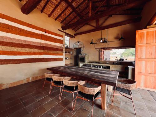 a kitchen with a large wooden table and chairs at Casa Bocore in Barichara
