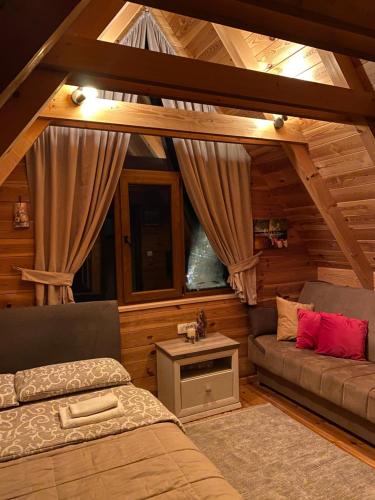 a room with a bed and a couch in a cabin at Blue Village 8 in Kolašin