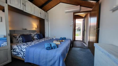 a bedroom with a bed with blue towels on it at Perlica in Vodice